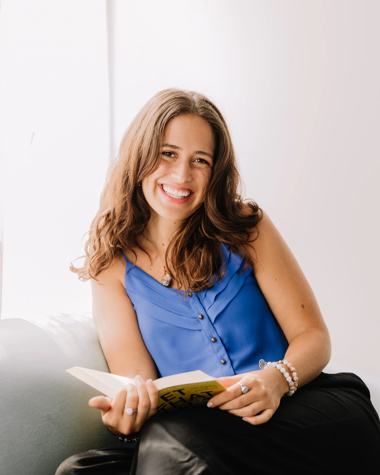 Emily Parolin, coach, sitting with a book